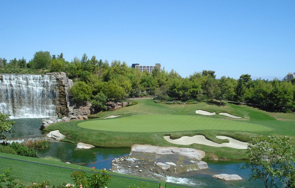 A scenic view of greenery and stunning waterfalls at the Wynn Golf Club