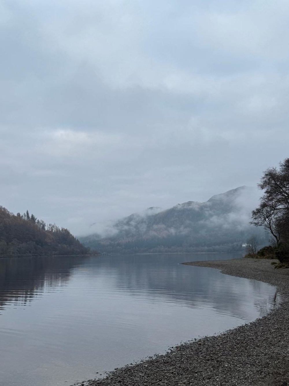 Foggy view of Loch Ness and Scottish Highlands on a calm morning