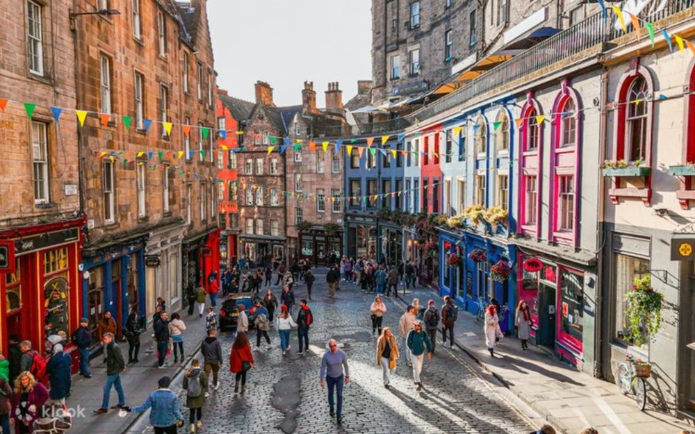 The colorful Victoria Street filled with people and shops