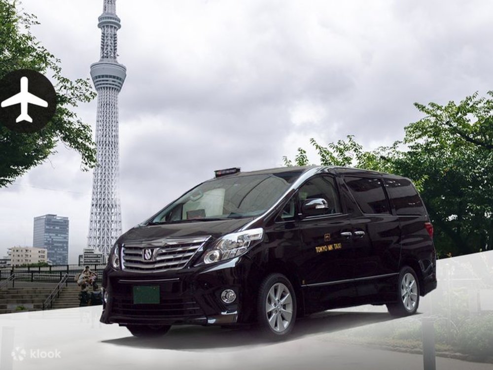 A black minivan with the Tokyo Skytree in the background