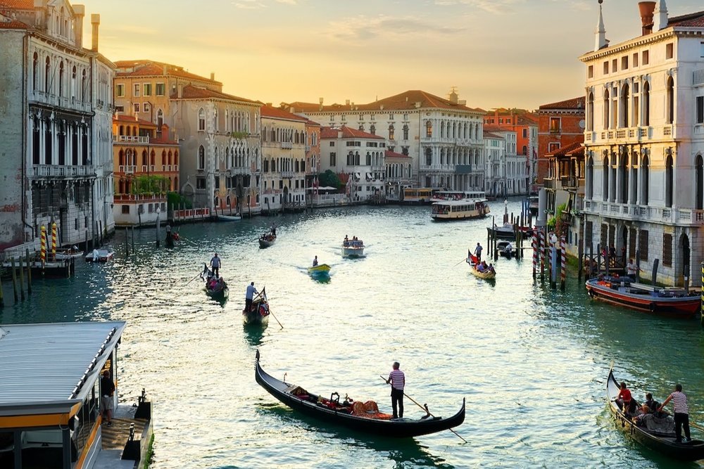 Gondolas at a river at sunset