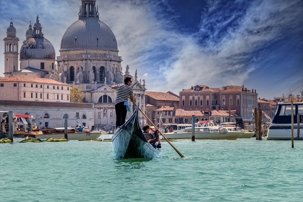 A gondola with the beautiful city of Venice as its backdrop