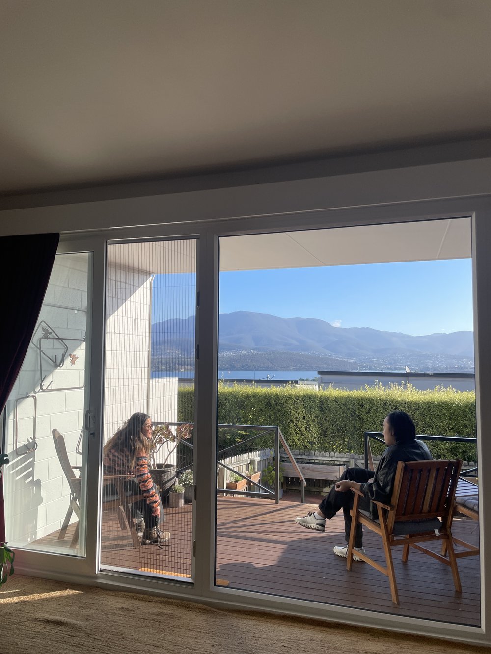 two friends in balcony overlooking tasmania