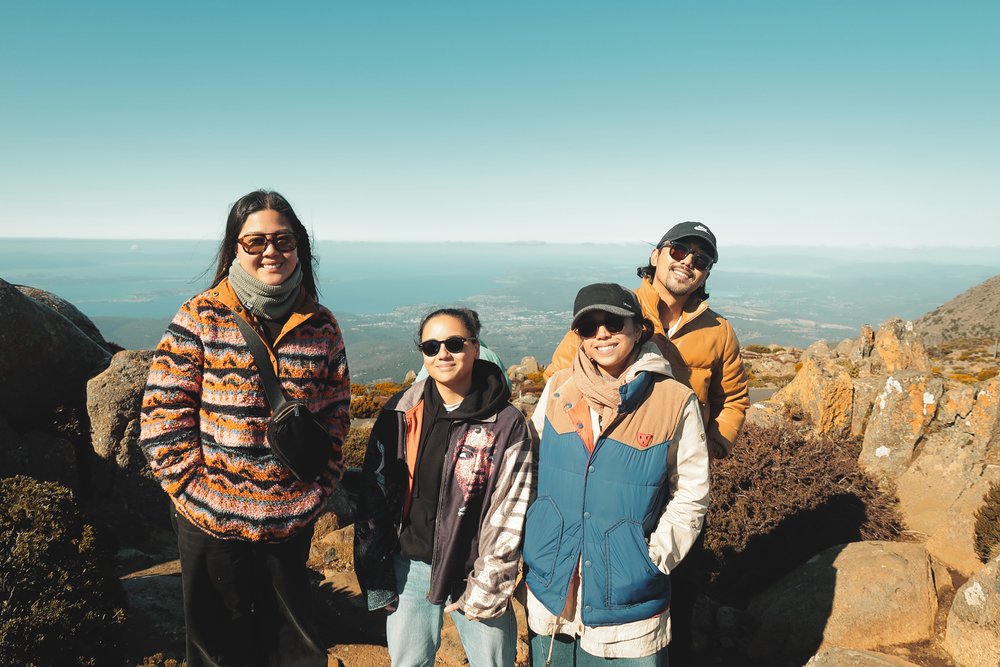 four friends taking a photo by Mount Wellington