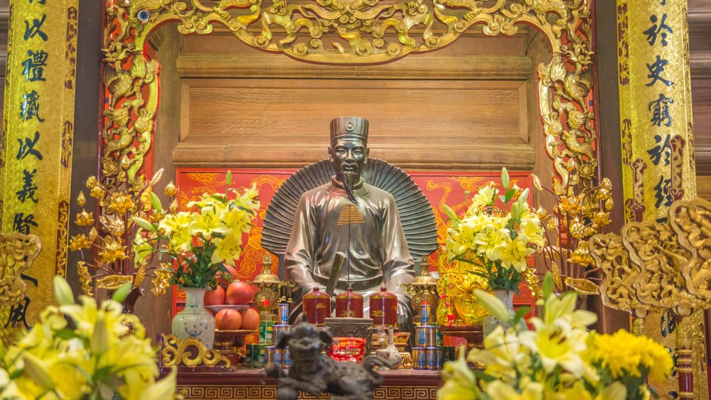  Golden altar with Confucius statue and offerings at Temple of Literature Hanoi
