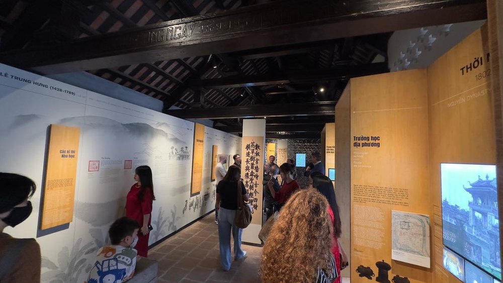 Visitors viewing educational displays at Temple of Literature’s museum hall