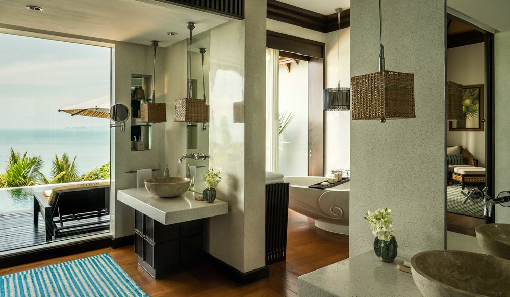 A luxurious bathroom with a freestanding bathtub and a view of the ocean