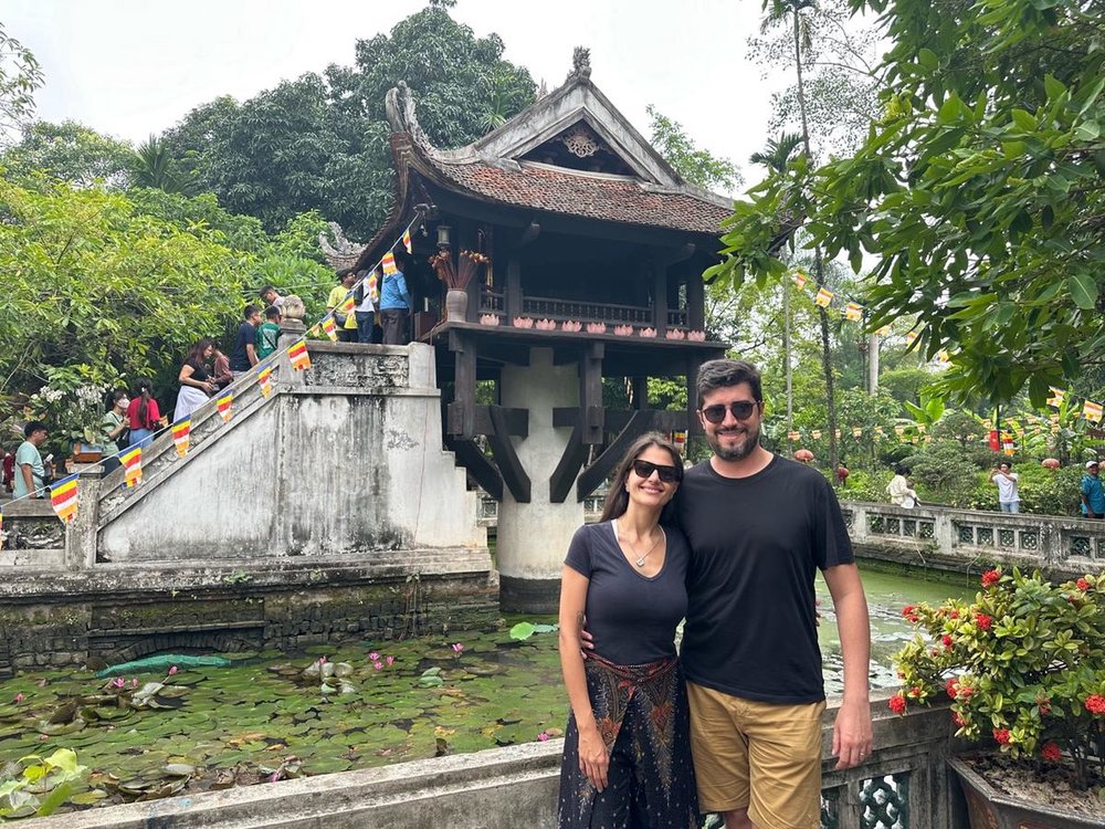 Tourists taking photos in front of the One Pillar Pagoda