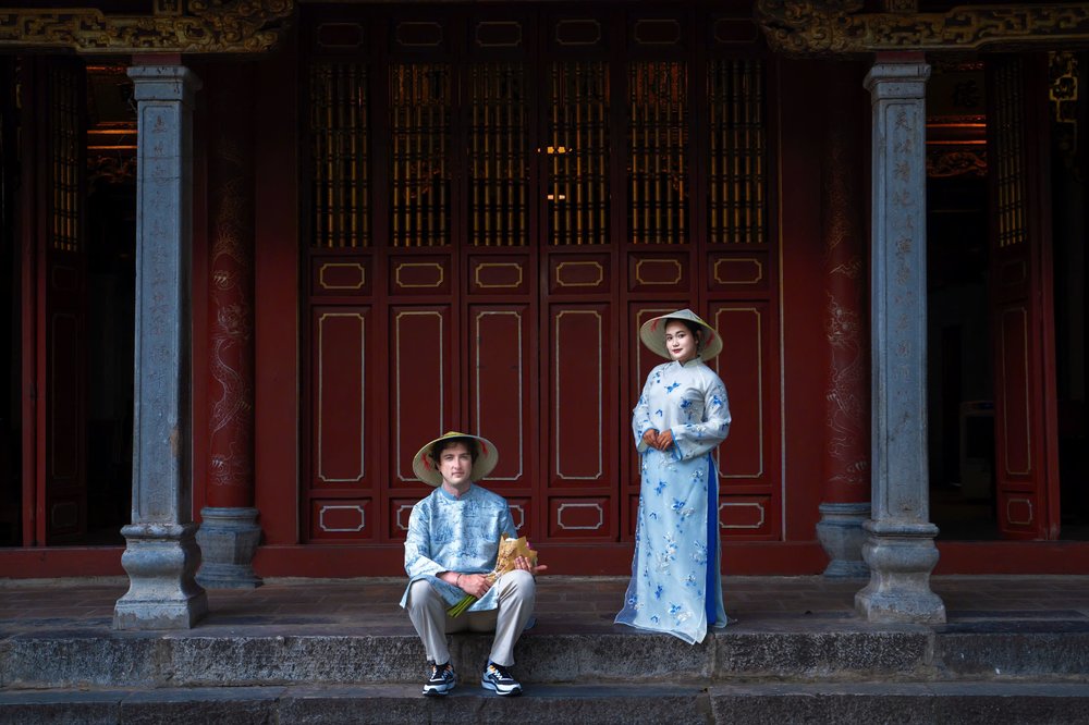Couple wearing traditional Ao Dai posing at a heritage site in Hanoi Old
