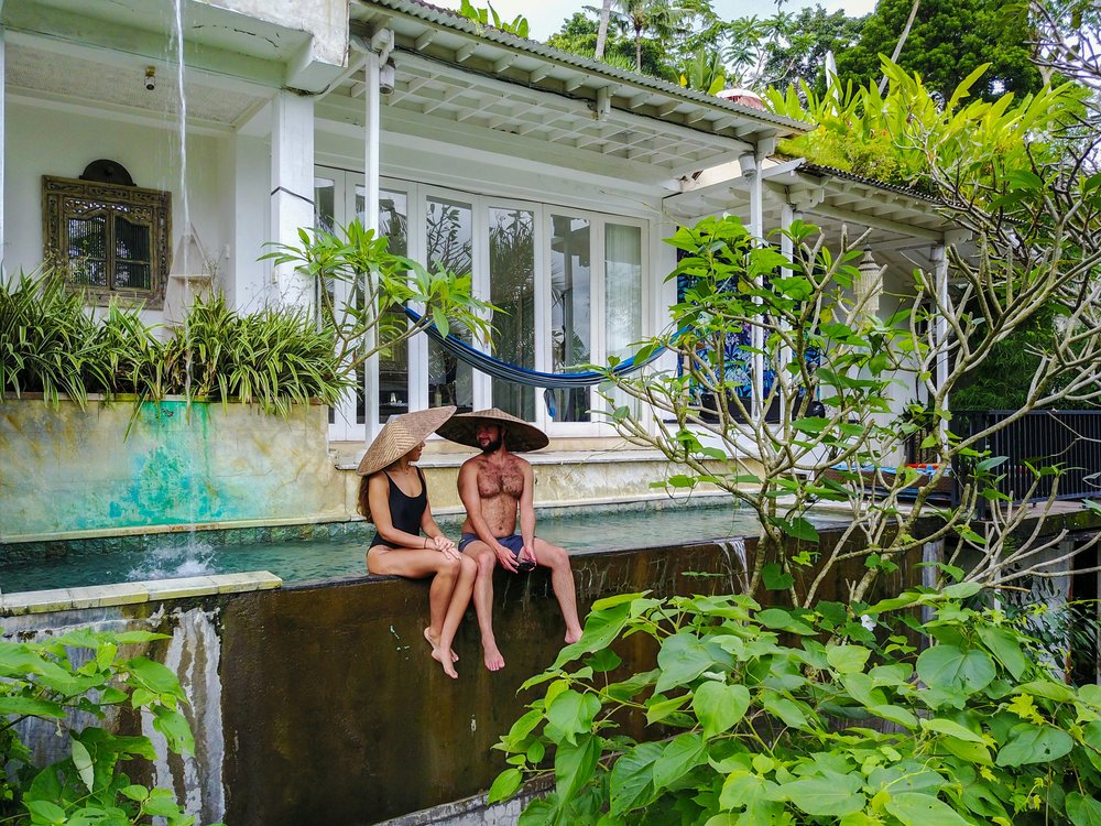 A couple seated by the pool