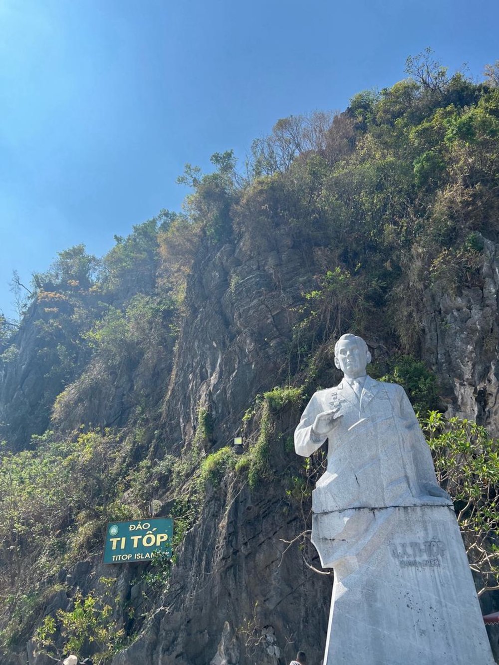 Ti Top Island statue beneath rocky cliffs and blue skies in Halong Bay, Vietnam