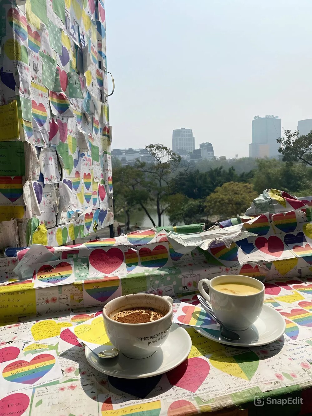 Two cups of hot coffee on top of handwritten notes