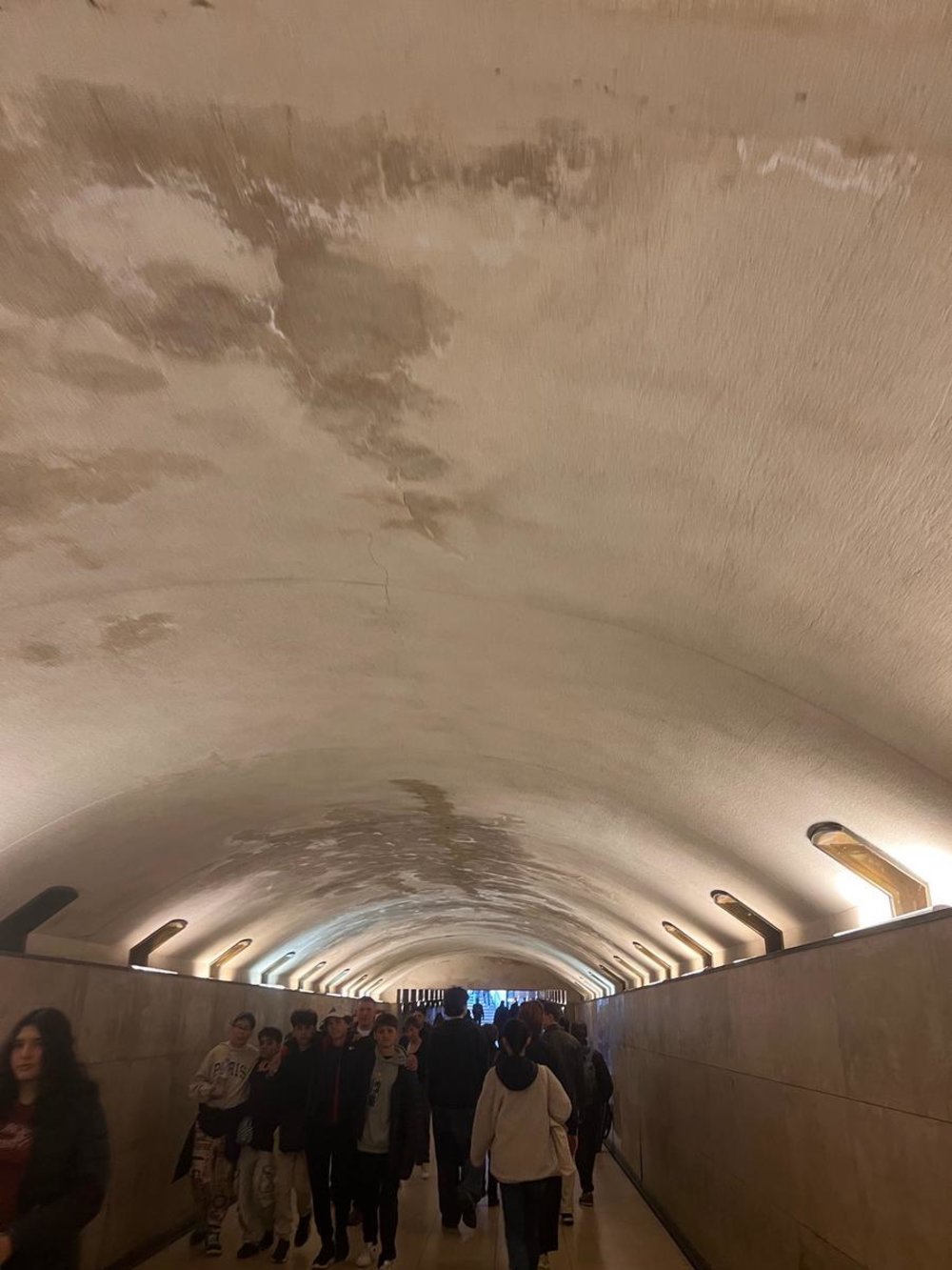 Visitors walking through the Arc de Triomphe’s underground passageway