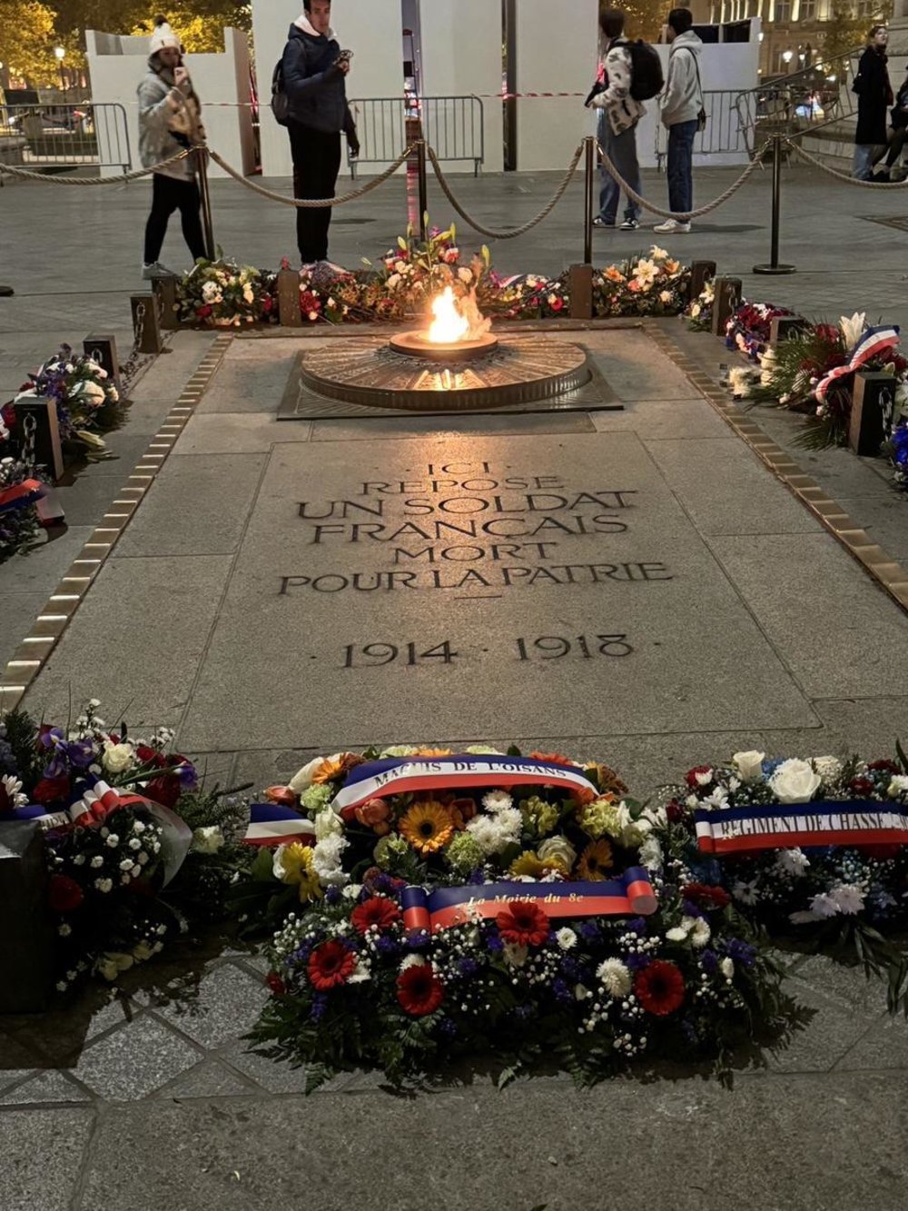 Eternal flame and floral tributes at the Tomb of the Unknown Soldier in Paris