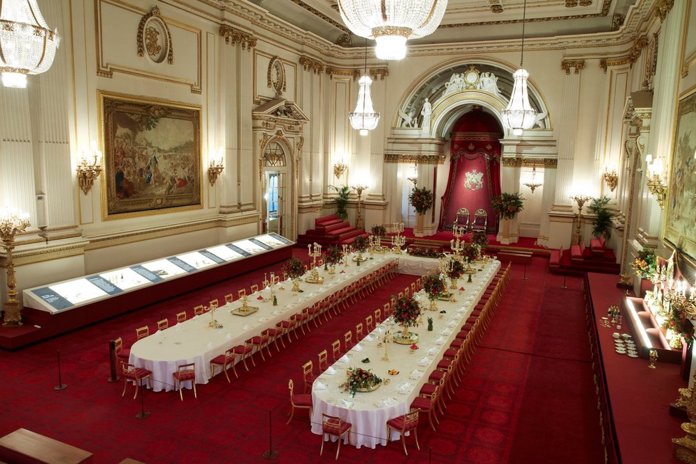 Buckingham Palace Grand Ballroom with banquet tables and chandeliers.