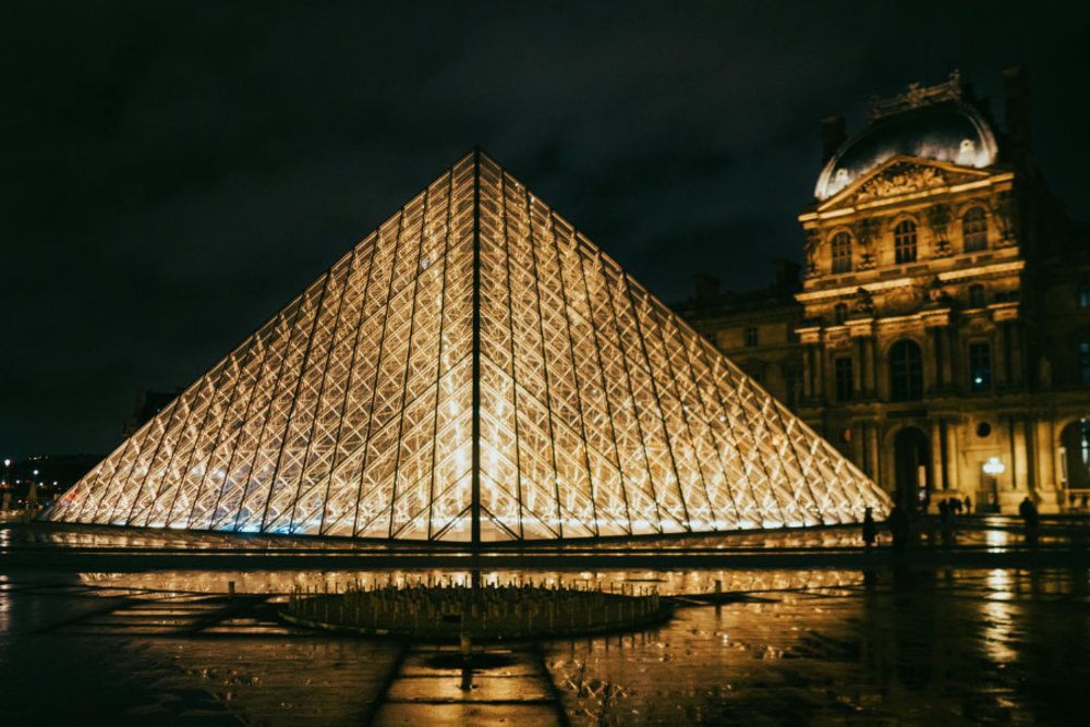 Louvre Museum illuminated at night in Paris, France 