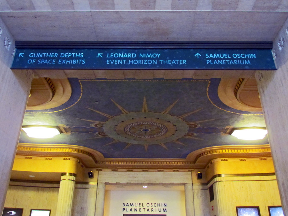 Sign pointing to the Samuel Oschin Planetarium and other Griffith Observatory exhibits