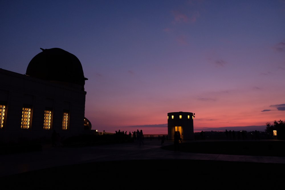 Griffith Observatory silhouetted against a vibrant Los Angeles sunset sky