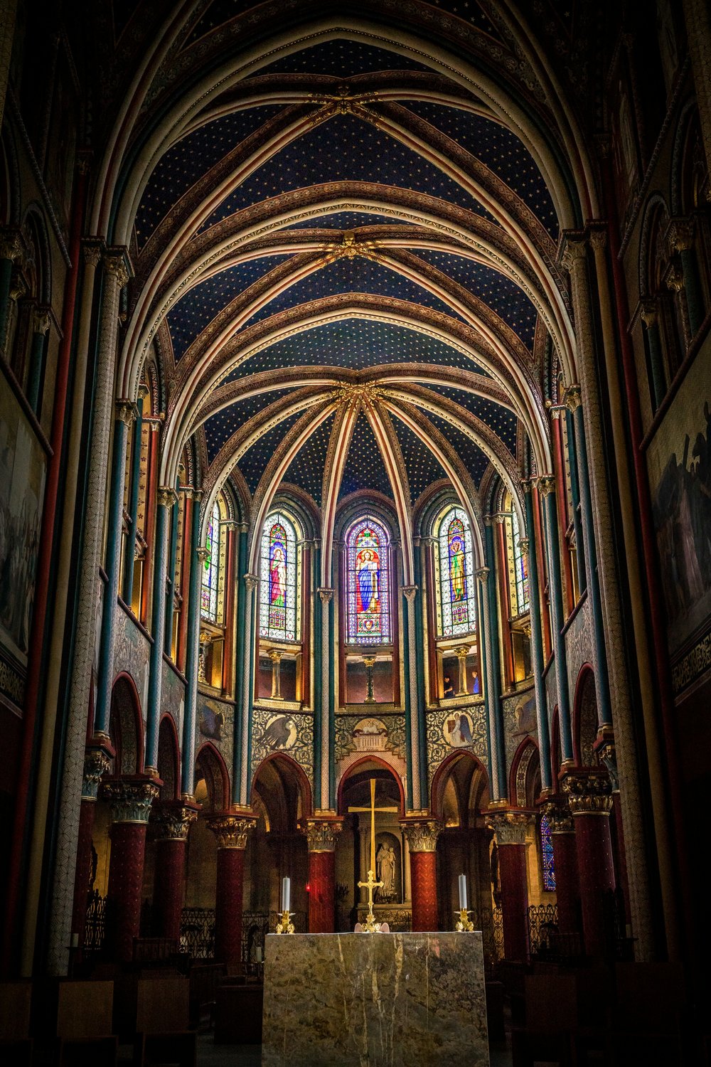 The pointed arches and stained glass windows inside the Church of Saint-Germain-des-Prés