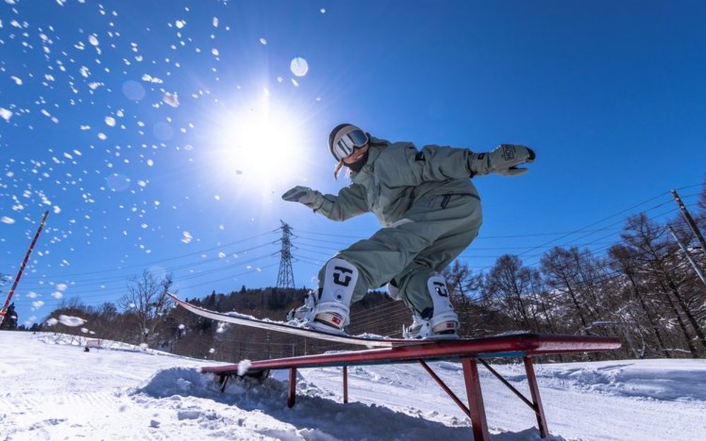  A snowboarder performs a trick on a rail 