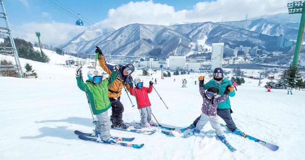 A family of five posing in their ski gear at Naeba Ski Resort