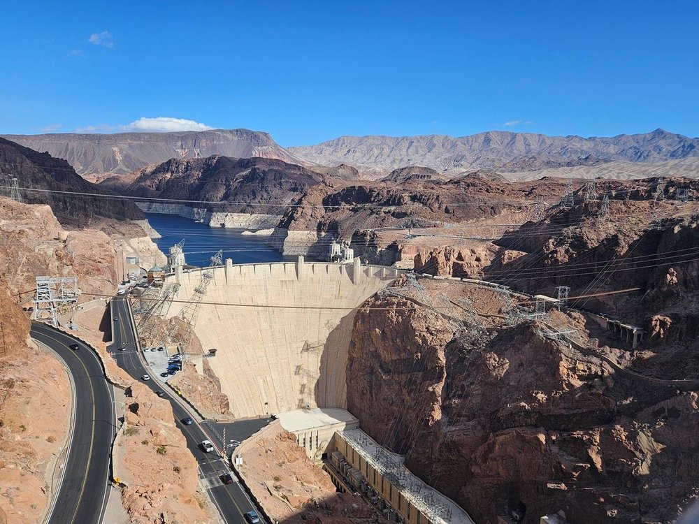 Hoover Dam surrounded by red rock canyons and Lake Mead in the distance