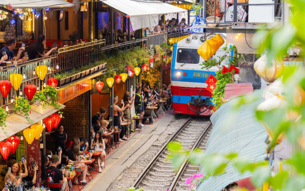 Train arriving at the Hanoi Train Street
