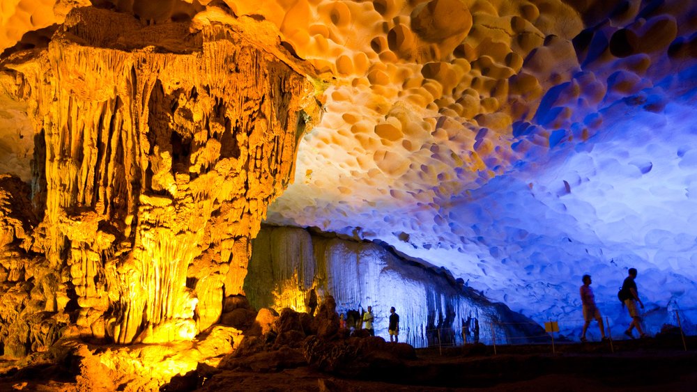 Thien Cung Cave illuminated with golden and blue lights in Ha Long Bay