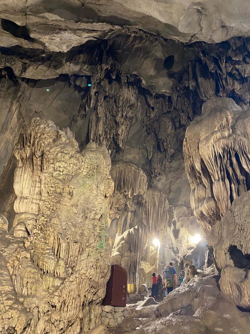 Huong Tich Cave interior with stalactites and worshippers inside
