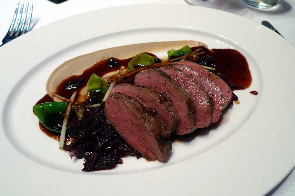 A dish of Saddle of Denham estate venison with braised red cabbage and blackcurrant sauce