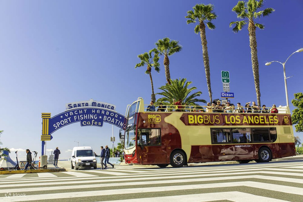 An LA Big Bus in front of Santa Monica Pier.