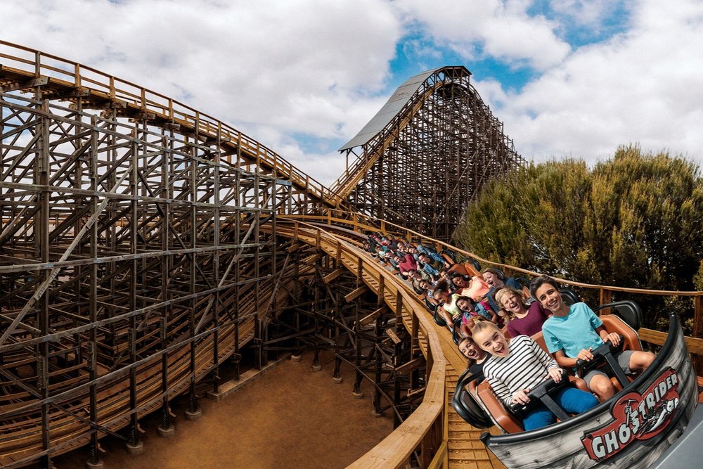 Visitors riding the Ghost Rider wooden roller coaster at Knott’s Berry Farm.