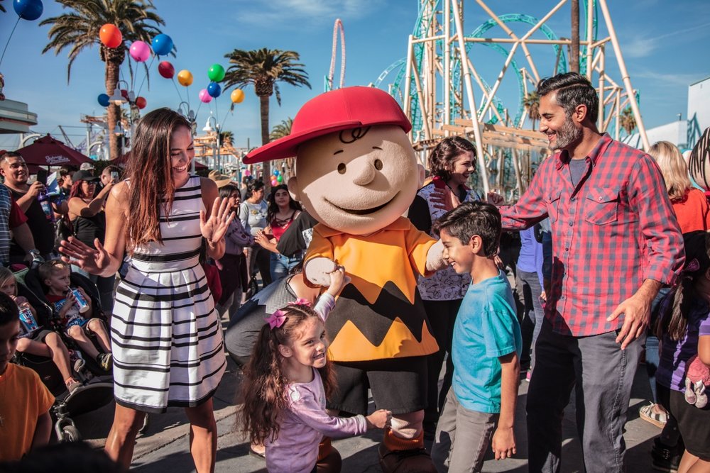 Family meeting Peanuts characters at Knott’s Berry Farm theme park.