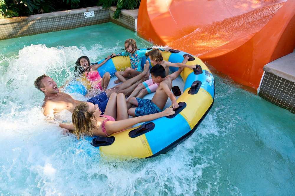 Parents and kids riding a water raft at LEGOLAND California Water Park.