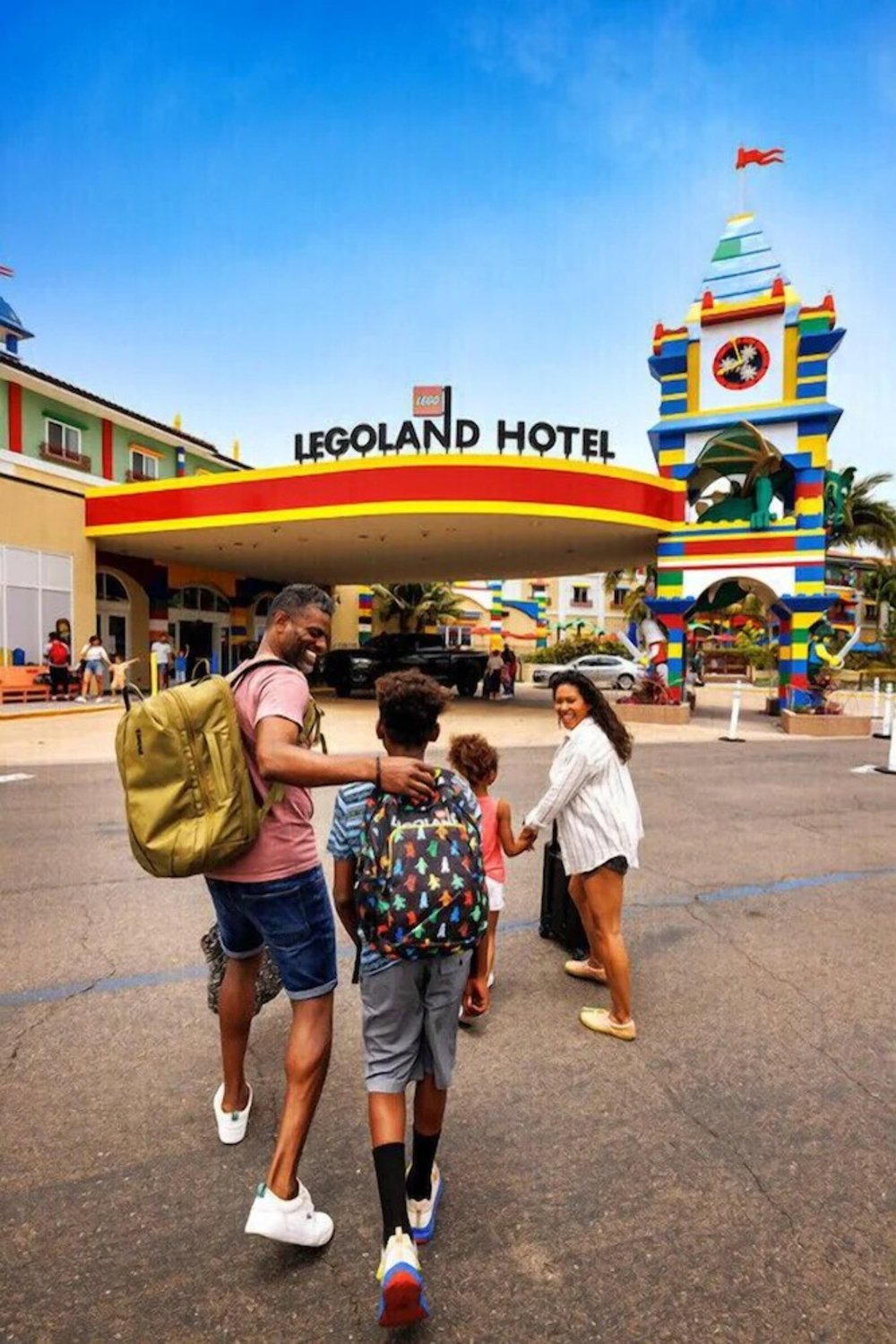 Family walking toward the entrance of the LEGOLAND Hotel California.