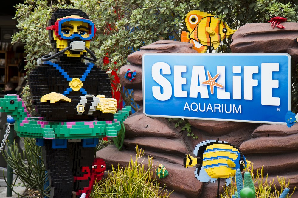 LEGO diver statue beside SEA LIFE Aquarium sign at LEGOLAND California.