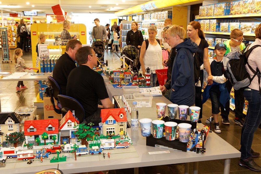 Visitors watching LEGO builders at work inside LEGOLAND California.