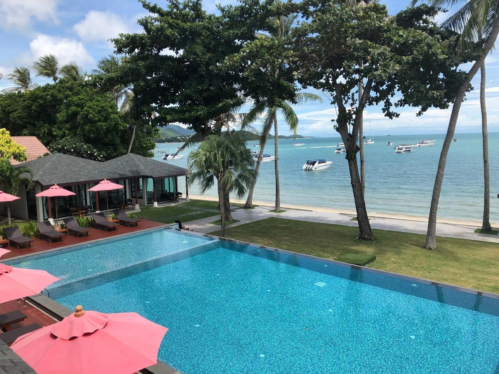 Poolside loungers and sea view at Samui Mermaid Beachfront Hotel, Bangrak