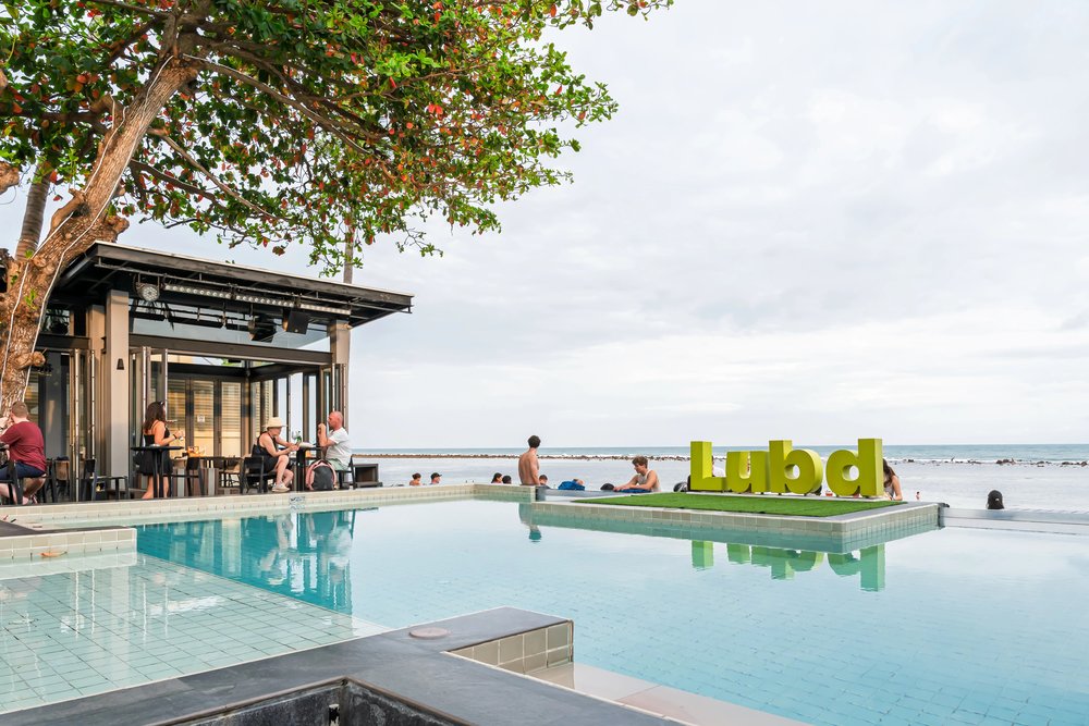 Travelers relaxing by the beachfront pool at Lub d Koh Samui Chaweng Beach