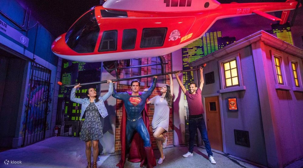 Visitors posing beside Superman at Madame Tussauds Sydney