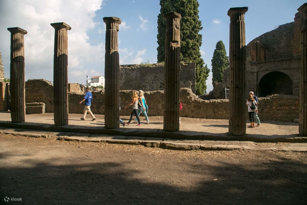 Visitors walking the cobbled streets of the Pompeii Ruins