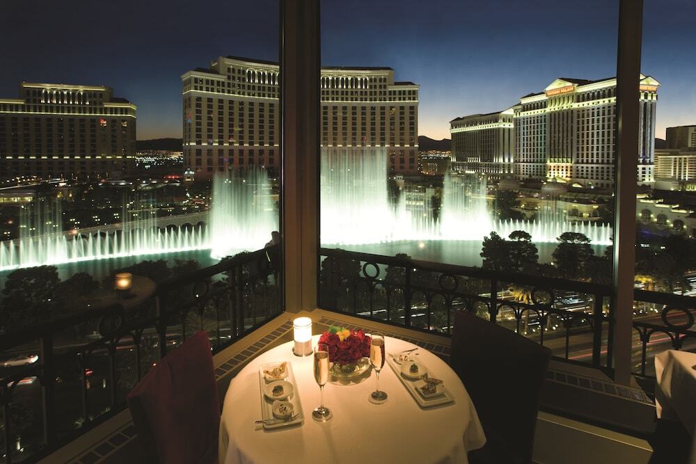 Table with a night view of the Bellagio Fountains from a Las Vegas restaurant