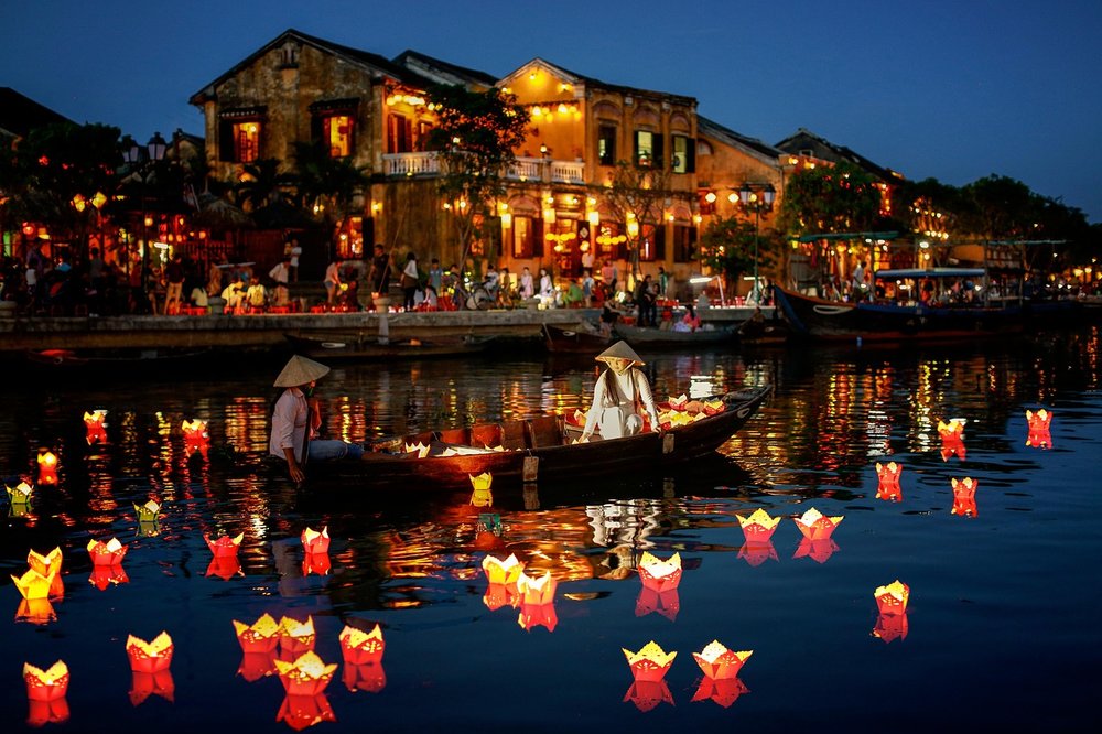 Alt Text: Lanterns floating downstream at the Ho Ai River in Hoi An