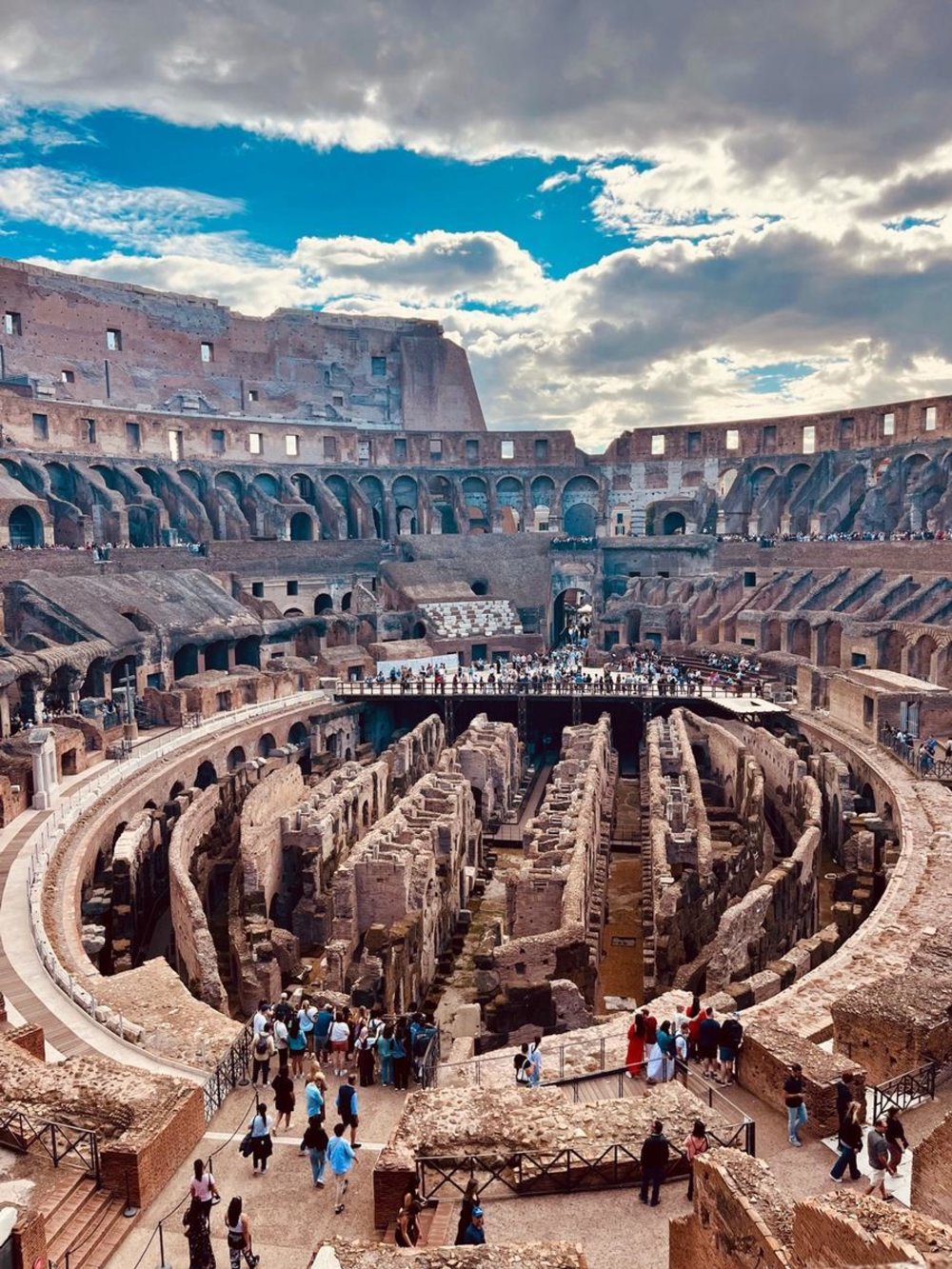 Interior view of the Colosseum showcasing the arena floor and visiting crowds
