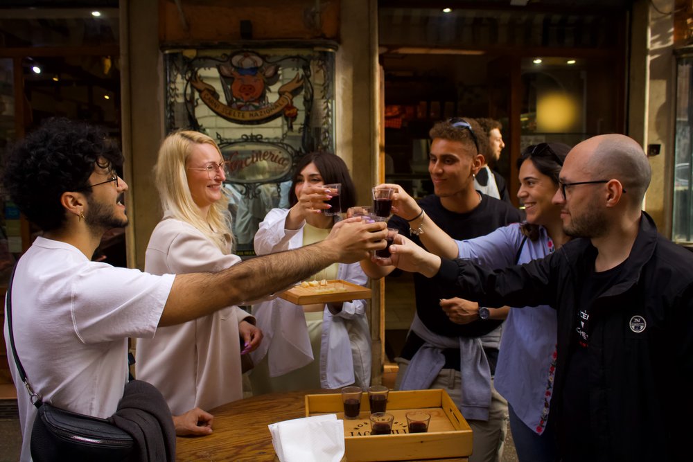 Group toasting with drinks during a food tour in Rome.