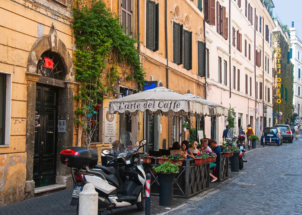 Outdoor café on a colorful street in Monti, Rome.