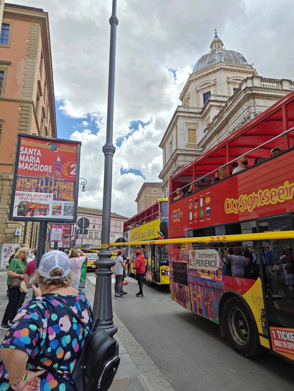 Travelers boarding hop-on hop-off buses near Santa Maria Maggiore