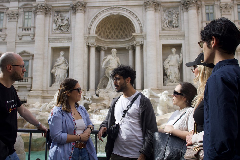 Group enjoying a guided tour at Trevi Fountain in Rome