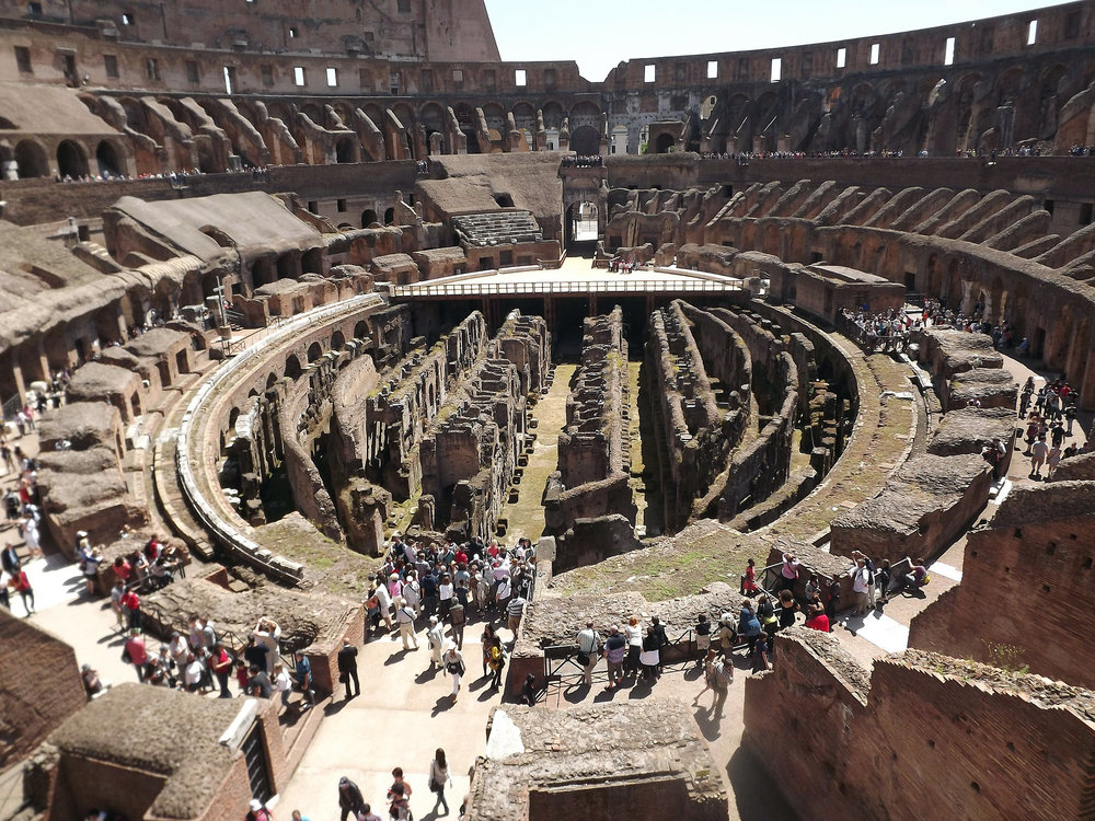  Interior of the Colosseum with crowds walking through ancient ruins