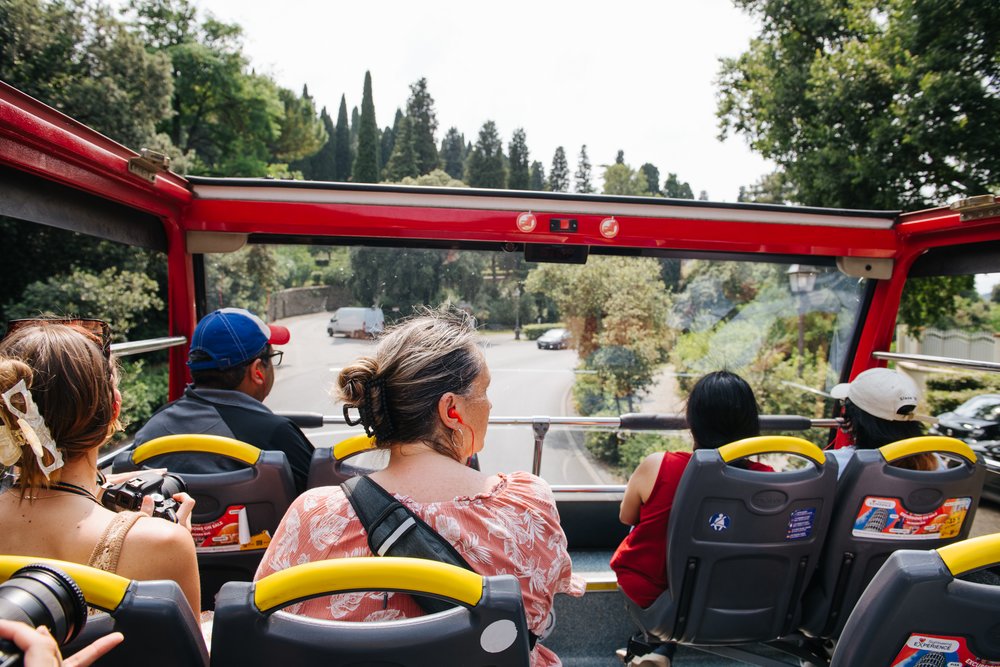 Passengers enjoying views from the open-top hop-on hop-off bus